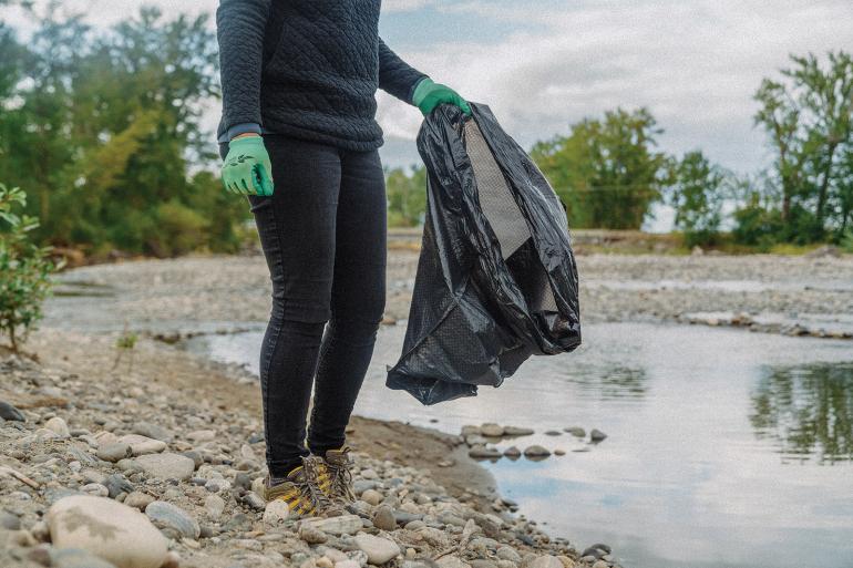 Picking up trash in river cleanup bozeman