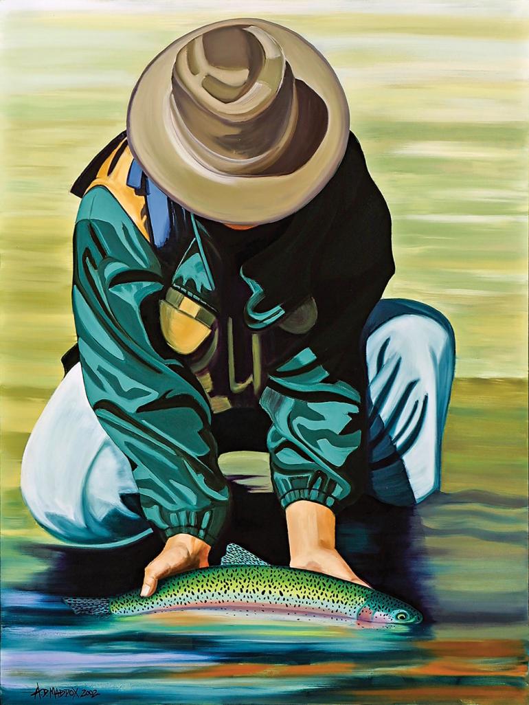 Man holding trout in river