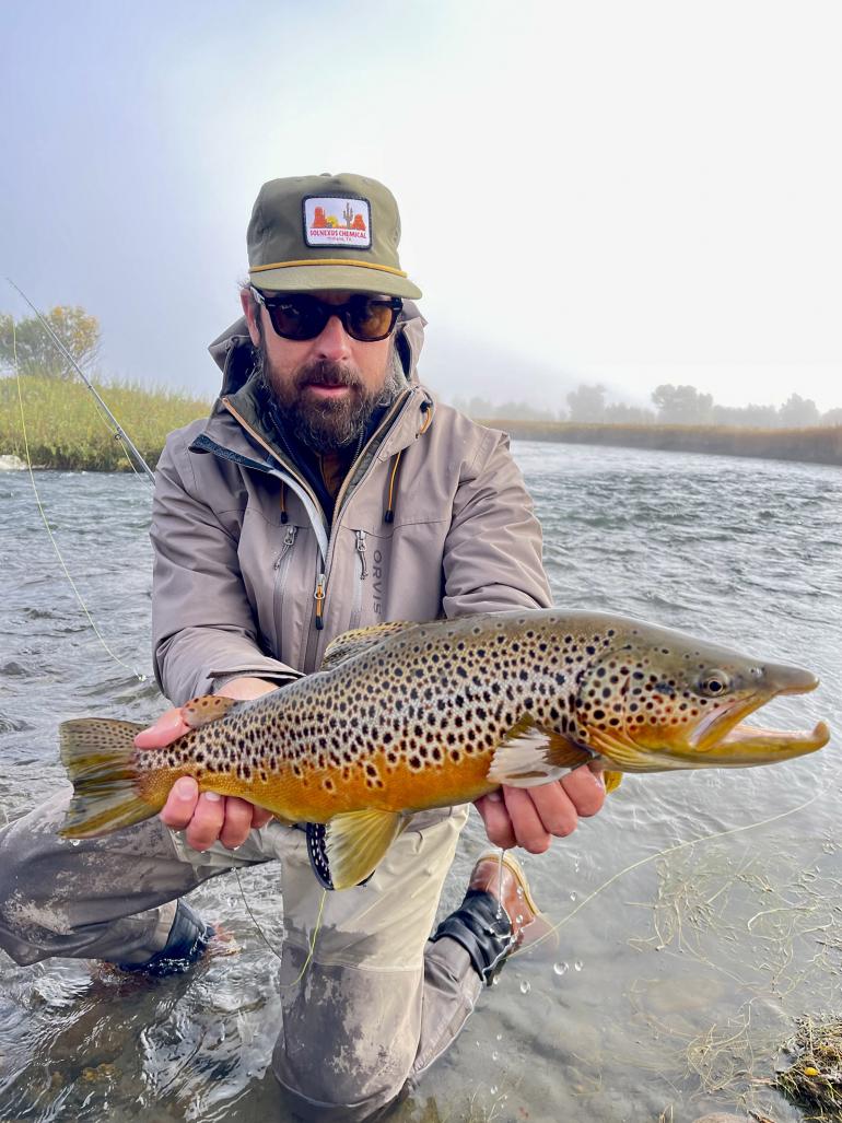 Fly fisherman with large brown trout