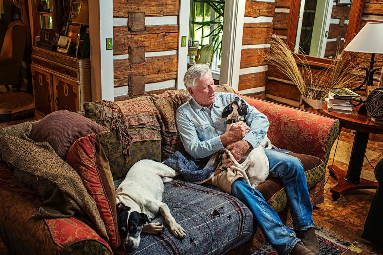 Thomas McGuane sitting with his dogs