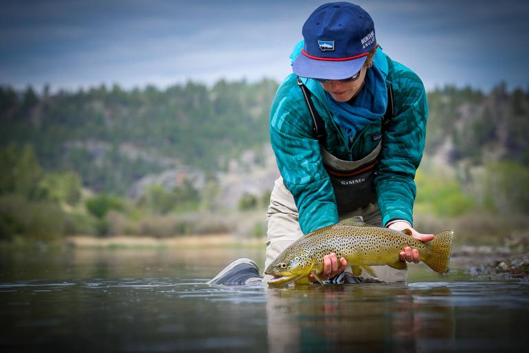 Angler holding a trout in the Missouri River