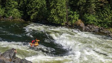 Running a rapid in a ducky, rafting