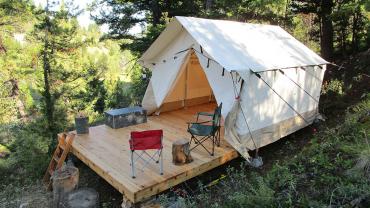 wall tent in woods on platform 10x12 white duck