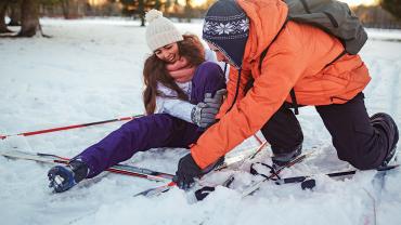 couple Nordic skiing falling