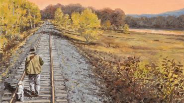 bird hunting dog walking on train track