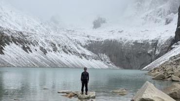 Omar Alveraz standing before a glacial lake in Patagonia