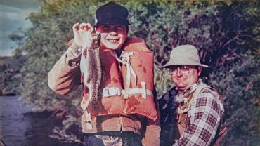 A boy catches his first Montana trout