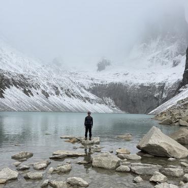 Omar Alveraz standing before a glacial lake in Patagonia