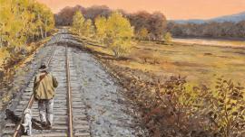 bird hunting dog walking on train track