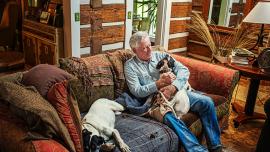 Thomas McGuane sitting with his dogs
