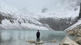 Omar Alveraz standing before a glacial lake in Patagonia