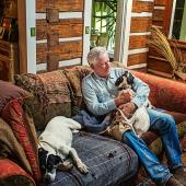 Thomas McGuane sitting with his dogs