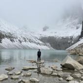 Omar Alveraz standing before a glacial lake in Patagonia