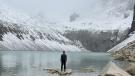 Omar Alveraz standing before a glacial lake in Patagonia